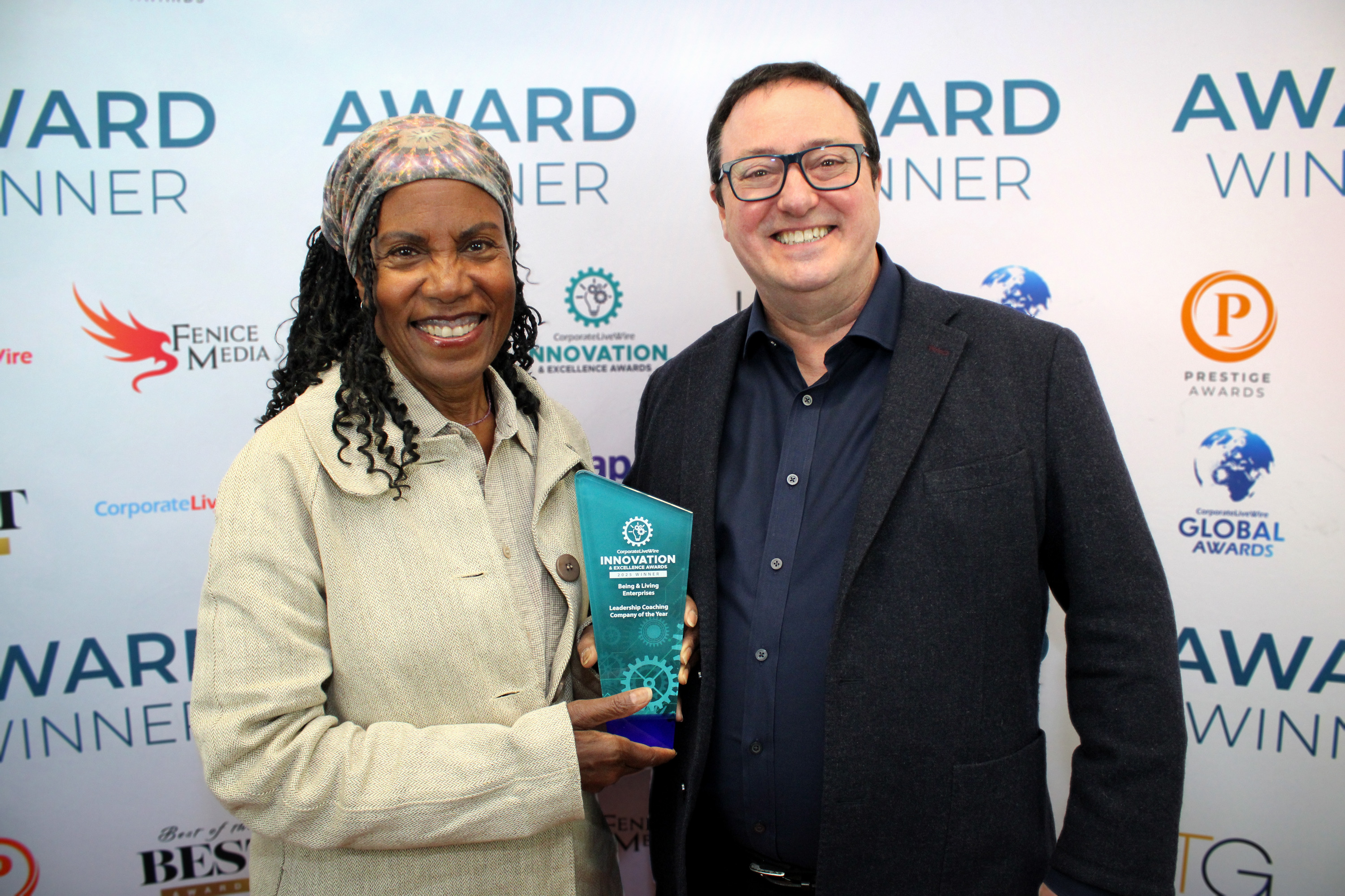 Photo of David Hall presenting award trophy to Leilani Henry with Corporate LiveWire Award Winner background